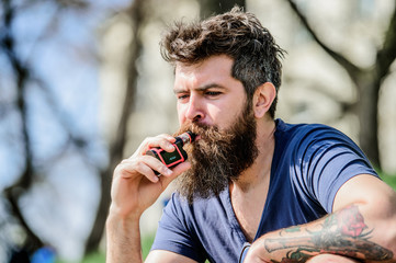 Health safety and addiction. inhaling vapor. Bearded brutal male smoking electronic cigarette....