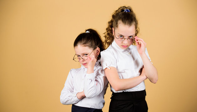 small girls in school uniform. confident students. friendship forever. back to school. study concept. smart small girls at lesson. Homeschooling concept. serious small girls. copy space