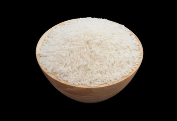 White rice in wooden bowl isolated on black