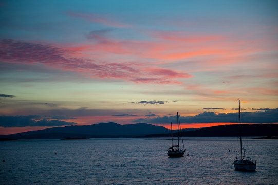 Ships on quiet lake at sunset, Oban, Scottland
