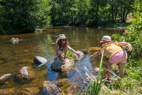 Auvergne - Rhone-Alpes - Haute-Loire - Saint-Julien-d'Ance - Girls playing on the bank of the Ance river.