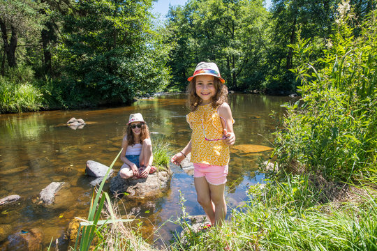 Auvergne - Rhone-Alpes - Haute-Loire - Saint-Julien-d'Ance - Girls playing on the bank of the Ance river.