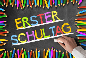 colorful words ERSTER SCHULTAG, German for first day of school, written on chalkboard framed by...
