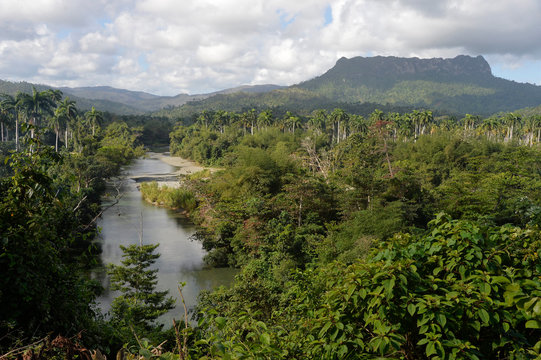 Cuba, Baracoa, landscape made of lush vegetation crossed by the Duaba river and dominated by the emblematic summit of the Yunque mountain