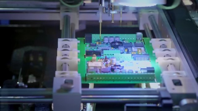 Electronic circuit board production. Automated Circut Board machine Produces Printed digital electronic board. Electronics contract manufacturing. Manufacture of electronic chips. High-tech.