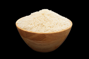 Rice in wooden bowl isolated on black background