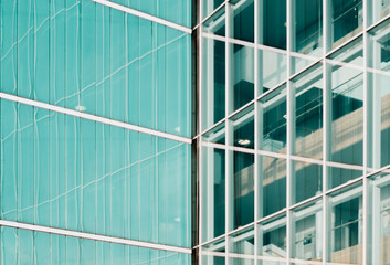 turquoise and glass facades of modern architecture buildings with reflection