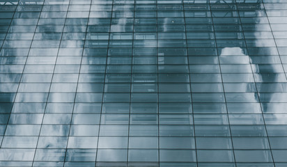 Blue sky and clouds reflected in windows of modern building
