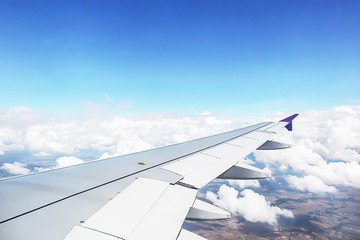 Dramatic atmosphere panorama view of beautiful blue sky and soft white clouds from aircraft window.