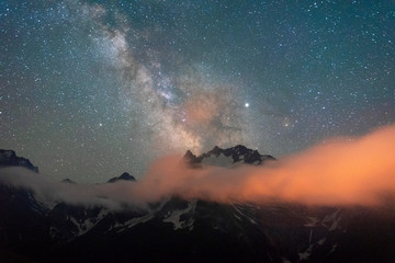 night sky with stars Milky Way over the mountains of the Caucasus with clouds