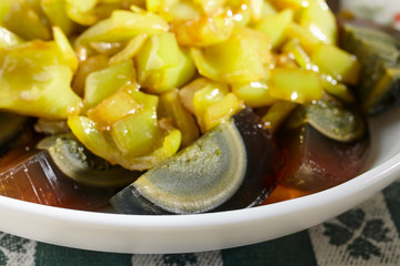 A cold dish of century egg wedges and fried green peppers. Sometimes called a pidan salad.