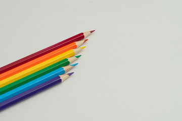 Colorful pencils of rainbow colors on white background. lose-up. Set of colorful pencils, copy space. Top view, flat lay. Back to school. Concept of LGBT
