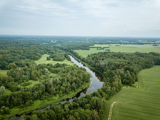 Fototapeta na wymiar country river in green forest. drone aerial image