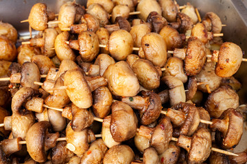 Grilled champignon mushrooms fried on fire