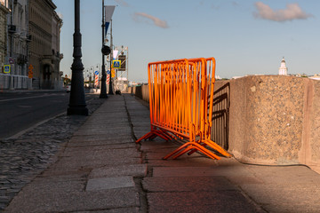 composed of metal fences orange. Colored metal frames stand on the granite embankment