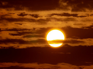 Sunset Shining Through The Fluffy Clouds