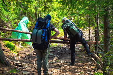 Two friends travel in the mountains with backpacks