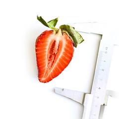 Big strawberry on a white background with caliper tool