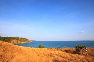 Beautiful seascape with sky twilight of sunset and sea horizon with Calm and blue sky.Dry grass field on mountain of Phrom Thep Cape is famous place in Phuket island, Thailand.