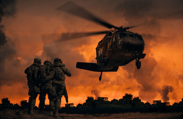 2 soldiers helping wounded soldier between dust in battle field to board the helicopter © Meysam Azarneshin