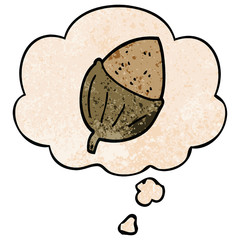 cartoon acorn and thought bubble in grunge texture pattern style