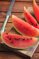 Fresh ripe sliced watermelon on wooden background