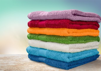 Pile of  fluffy towels on background