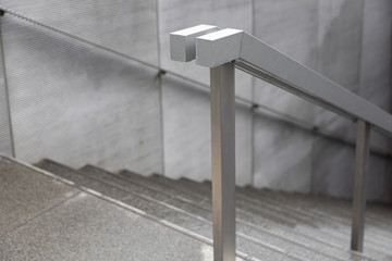 Close up of wet stainless steel railings pathway to tunnel.