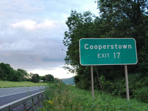 Highway exit sign for Cooperstown, home of the Baseball Hall of Fame and Glimmerglass Opera
