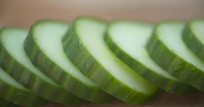 Macro close up along a row of freshly sliced English cucumber