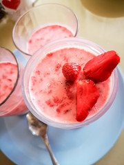Strawberry jelly in a glass cup, chia seed pudding with strawberries, on a blue plate