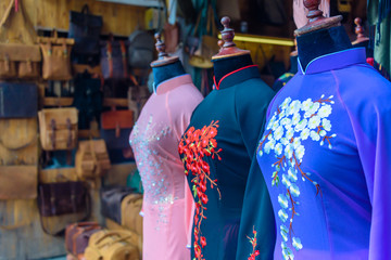 Obraz premium Dresses on display at one of the many made-to-order tailors shop in Hoi An, Vietnam