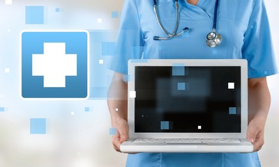 Close-up Doctor at hospital working with laptop