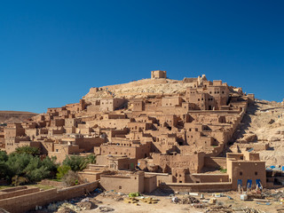 Ait Ben Haddou Kasbah, old medieval town in Morocco desert, castle fort gate, clay mud houses ruins, river in the mountiains