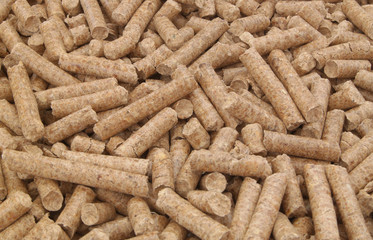 Natural wooden pellets background or pattern. Cheap energy and cats litter.
