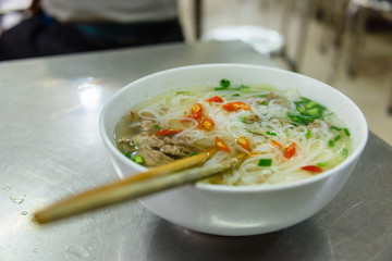 A bowl of chicken noodle soup for breakfast  in a restaurant in Hanoi, Vietnam