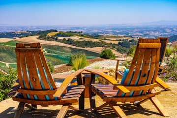 Chairs with a view over vineyards and hills