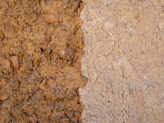 Clay mud and hay wall, wet and dry part, traditional building material, texture
