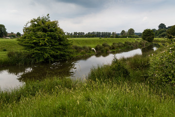 English rural landscape with river and reflections