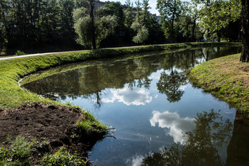 Pond lake river green grass summer landscape reflection in water sky clouds nature trees 