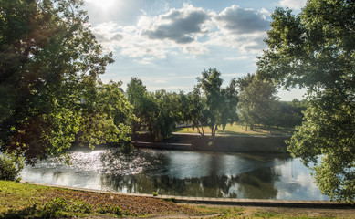 Summer outdoor park landscape blue sky green trees river lake water sun light recreation vacation day