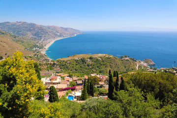Beautiful landscape panorama of Sicily coastline. Blue Mediterranean sea and green mountians, Taormina, Sicily island, Italy.