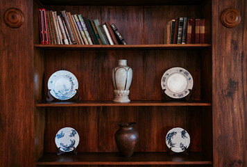 Old wood bookshelf with Chinaware plates, Vase and jar