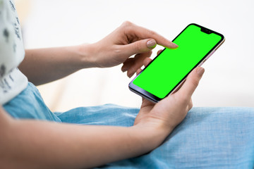 Close-up of female working using smartphone blurred images in