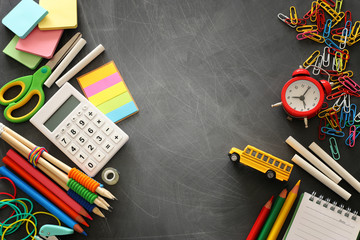 education and back to school concept. stationery and bus over classroom blackboard. top view, flat...