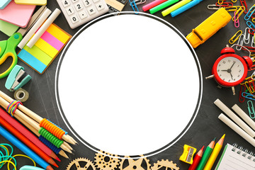 education and back to school concept. stationery and bus over classroom blackboard. top view, flat...