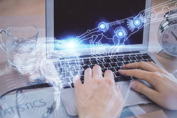 Man typing on keyboard background with brain hologram. Concept of big Data.