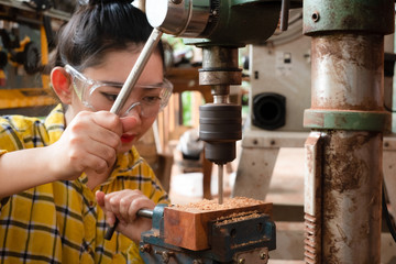 Women standing is craft working drill wood