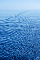 Obraz premium water ripple reflection of a calm wave in the ocean in a soft backlight