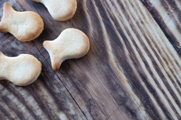 Close up cookies in the shape of fish on a wooden table